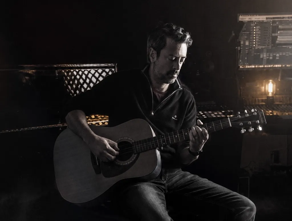 Midnight Arcade artist photo — guitarist performing in the studio